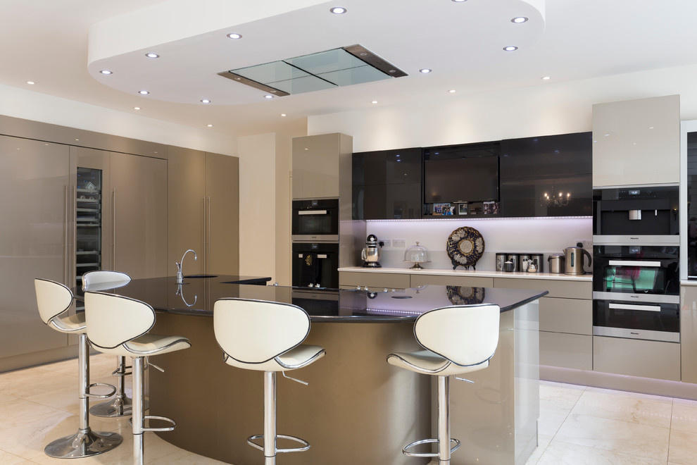 Photo of a large contemporary single-wall open plan kitchen in London with a double-bowl sink, flat-panel cabinets, granite benchtops, metallic splashback, glass sheet splashback, black appliances, marble floors, a peninsula and black cabinets.