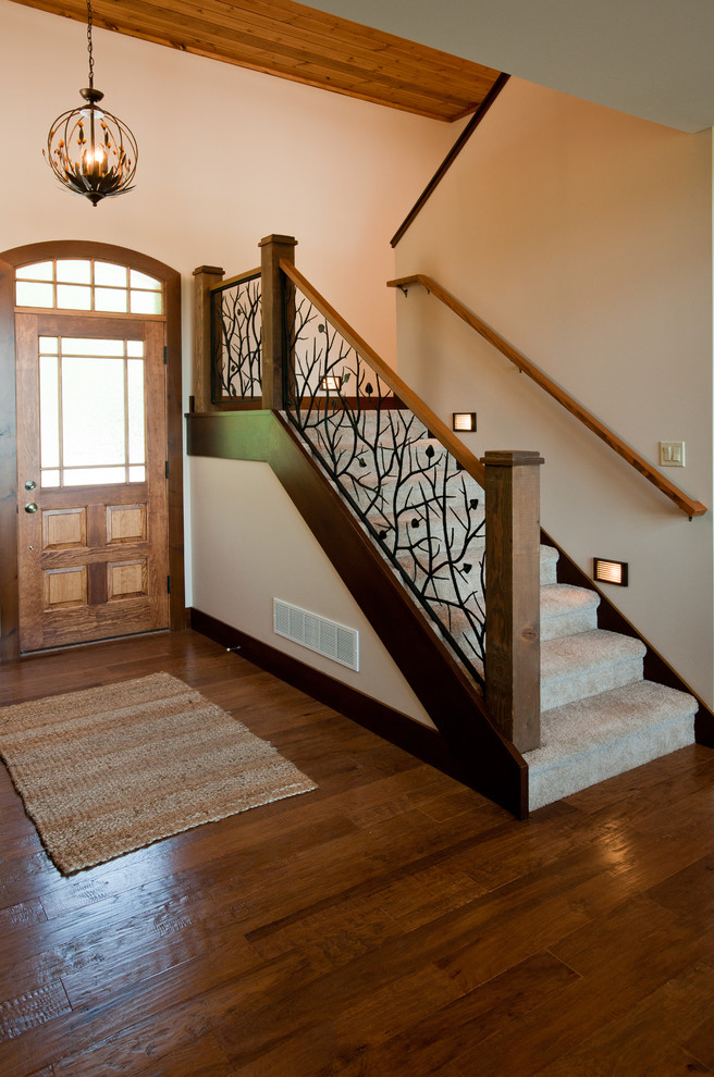 Large arts and crafts medium tone wood floor and brown floor front door photo with a medium wood front door and beige walls
