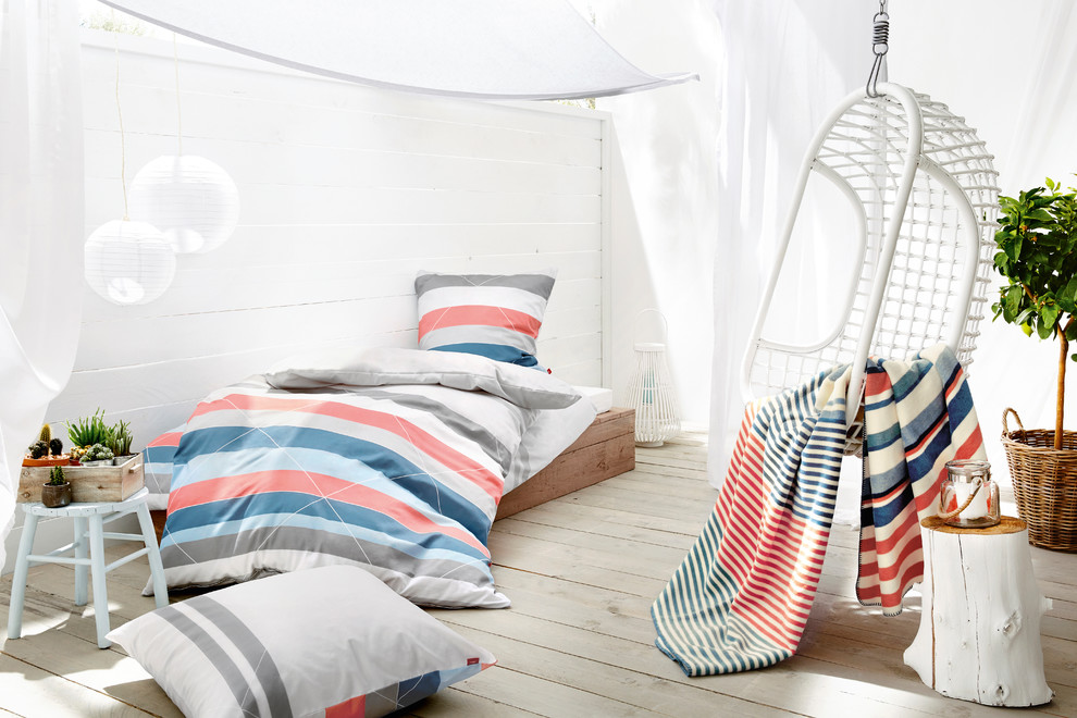 Design ideas for a small beach style guest bedroom in Other with white walls, painted wood floors, grey floor and no fireplace.