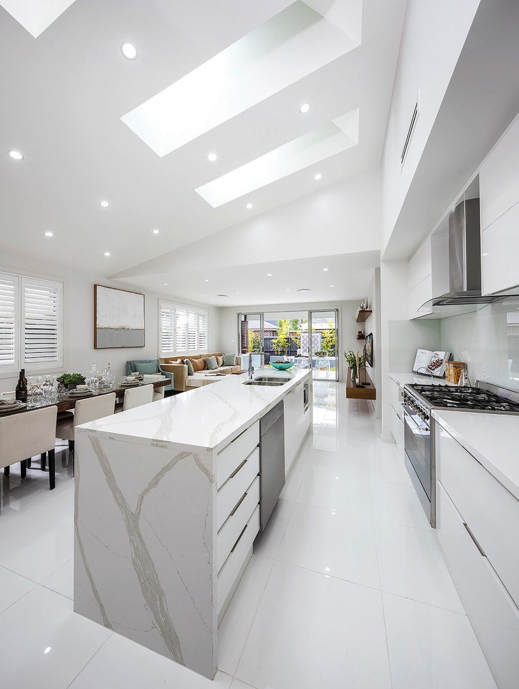 Inspiration for a mid-sized contemporary single-wall open plan kitchen in Sydney with an integrated sink, marble benchtops, white splashback, glass sheet splashback, stainless steel appliances, porcelain floors, a peninsula and white floor.