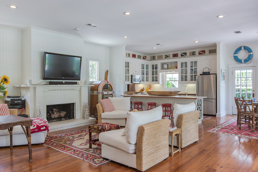 Inspiration for a mid-sized country open concept living room in Miami with beige walls, medium hardwood floors, a standard fireplace and a brick fireplace surround.