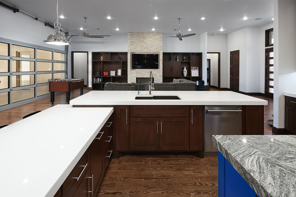 Photo of a large modern u-shaped eat-in kitchen in Oklahoma City with a drop-in sink, shaker cabinets, medium wood cabinets, quartz benchtops, white splashback, stainless steel appliances, medium hardwood floors, with island and brown floor.