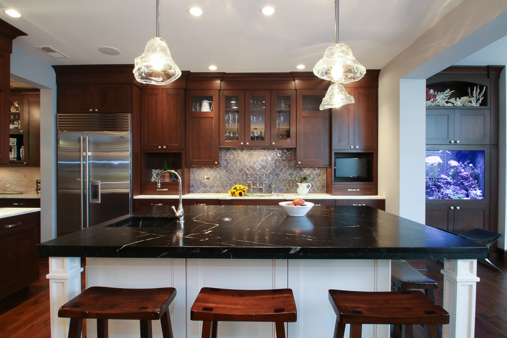 Example of a large transitional medium tone wood floor open concept kitchen design in Chicago with flat-panel cabinets, medium tone wood cabinets, marble countertops, blue backsplash, ceramic backsplash, stainless steel appliances and an island