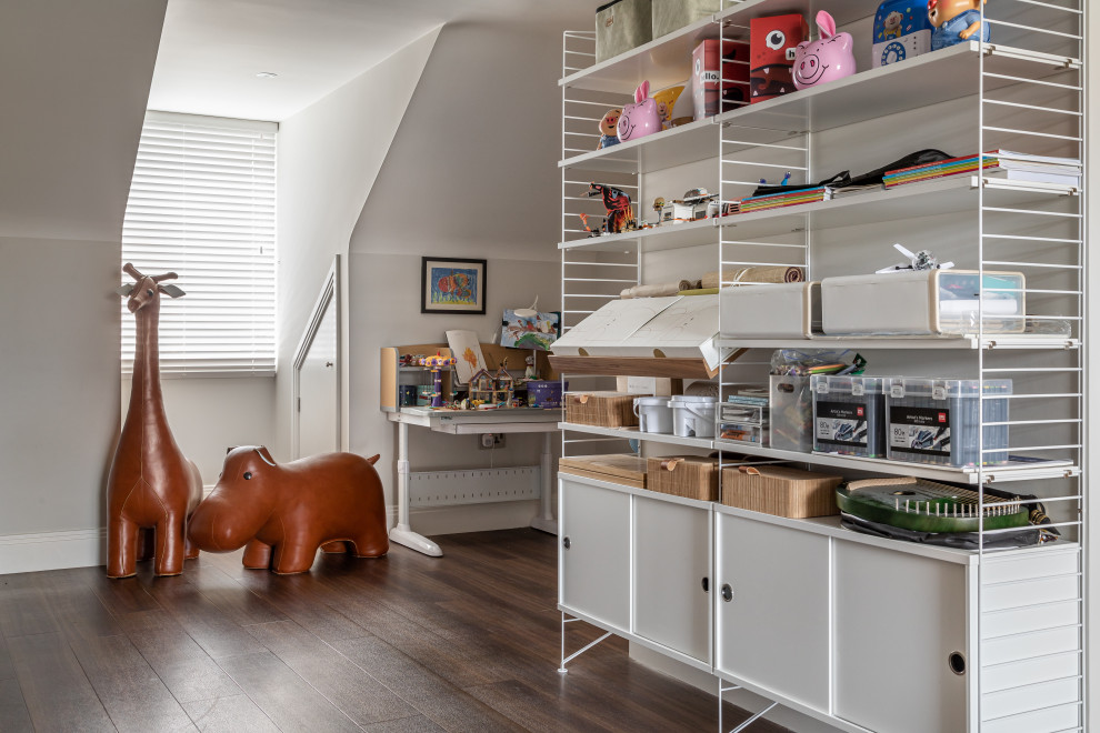 Contemporary gender-neutral kids' playroom in Cambridgeshire with laminate floors.