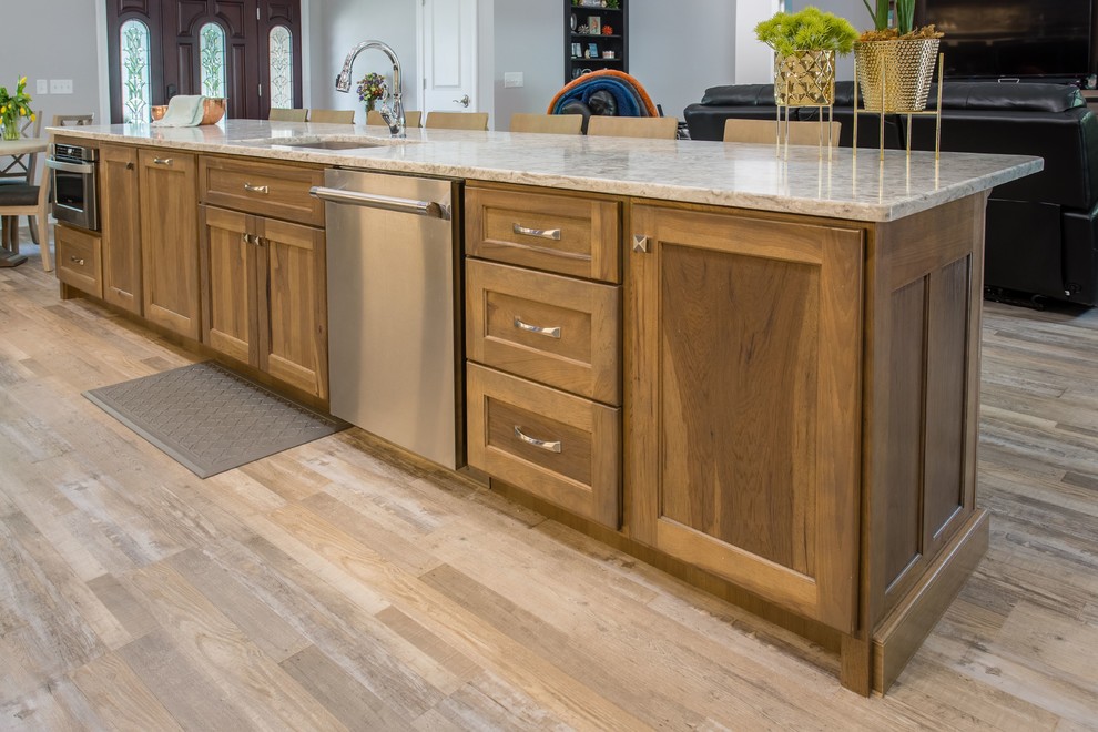 Open concept kitchen - transitional l-shaped open concept kitchen idea with shaker cabinets, stainless steel appliances and an island