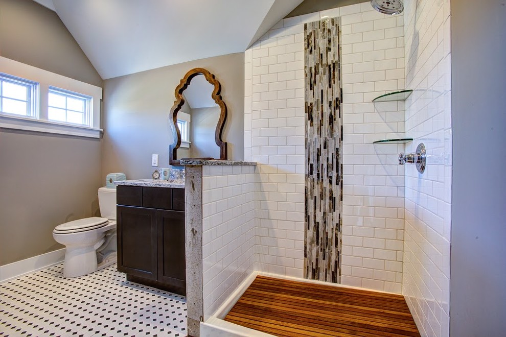 This is an example of a large traditional 3/4 bathroom in Other with recessed-panel cabinets, dark wood cabinets, a corner shower, a two-piece toilet, brown tile, white tile, subway tile, brown walls, porcelain floors, an undermount sink, granite benchtops, white floor and an open shower.