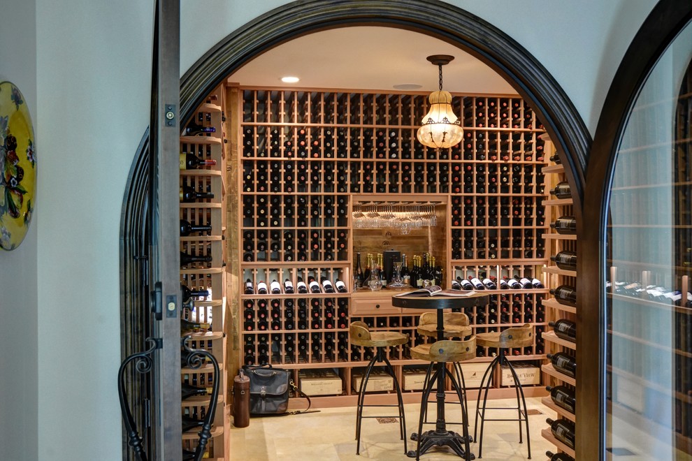 Design ideas for a large country wine cellar in Orange County with porcelain floors, display racks and beige floor.