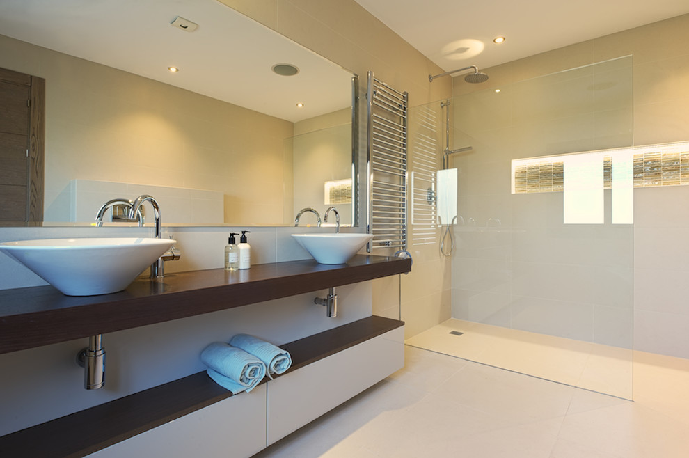 Design ideas for a mid-sized contemporary 3/4 bathroom in Other with open cabinets, a corner shower, beige tile, ceramic tile, beige walls, ceramic floors, a vessel sink, wood benchtops and brown benchtops.
