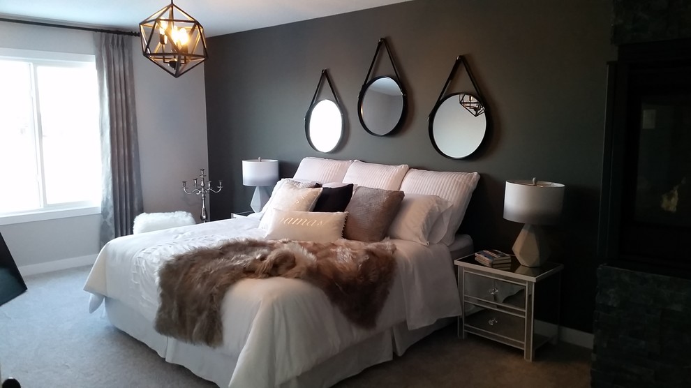 Example of a mid-sized transitional master carpeted bedroom design in Edmonton with gray walls, a two-sided fireplace and a stone fireplace
