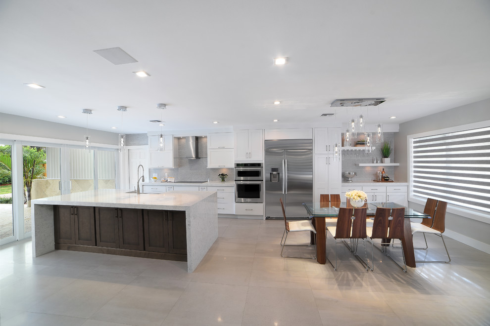 This is an example of a large modern open plan dining in Miami.