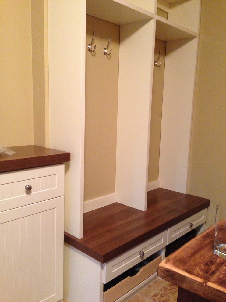 Mudroom - small rustic ceramic tile mudroom idea with beige walls