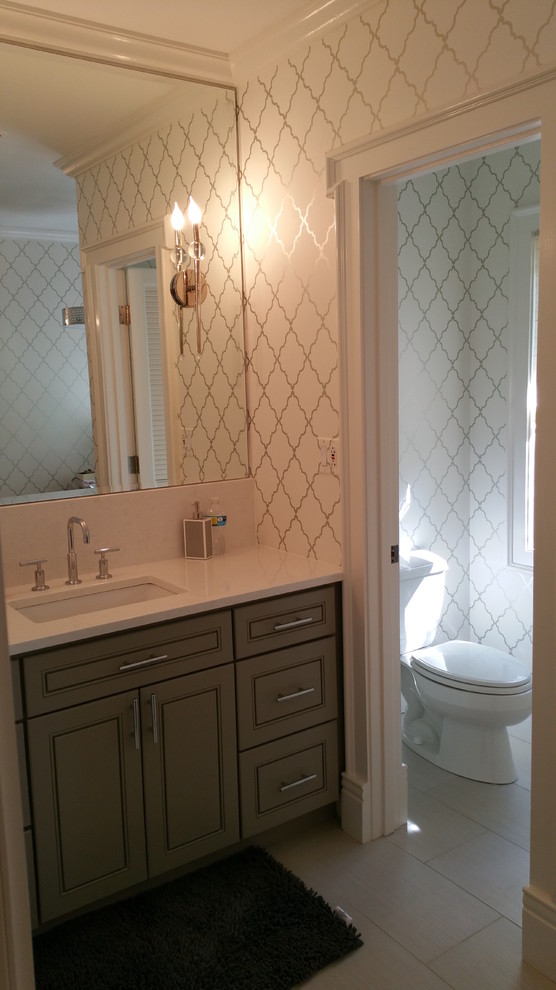 Transitional bathroom photo in Chicago with flat-panel cabinets, gray cabinets, a two-piece toilet and marble countertops