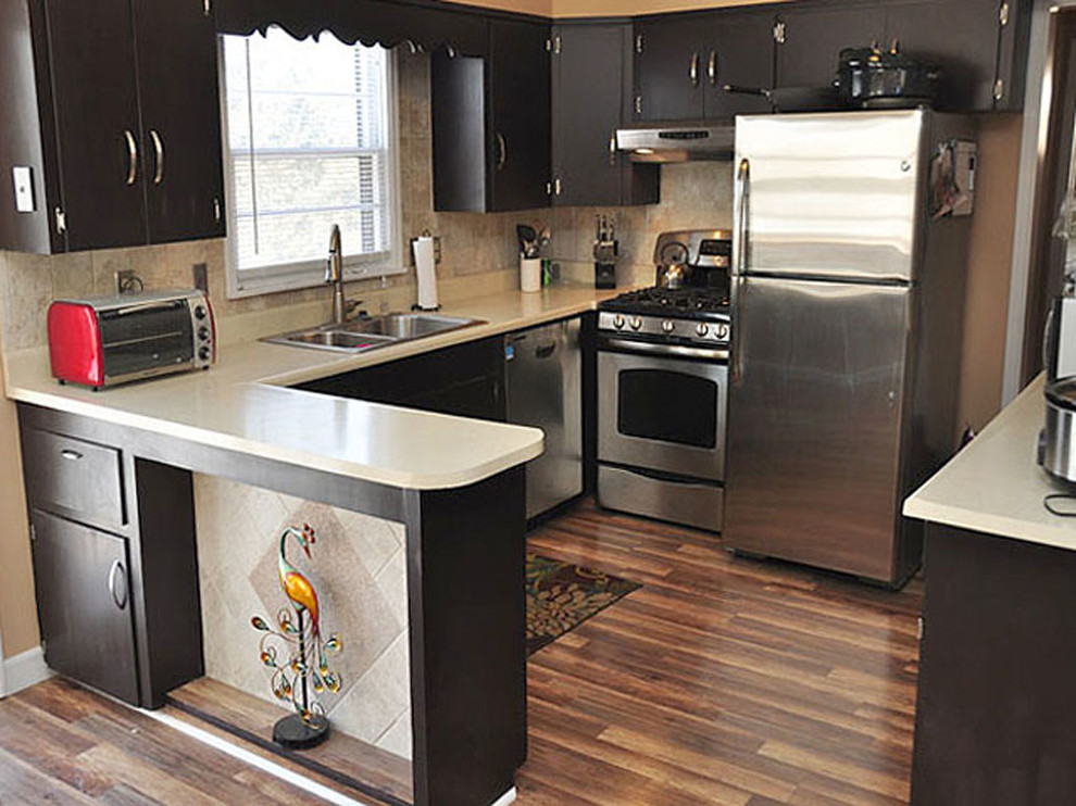Small transitional u-shaped medium tone wood floor eat-in kitchen photo in Omaha with a drop-in sink, flat-panel cabinets, dark wood cabinets, beige backsplash, ceramic backsplash, stainless steel appliances and a peninsula