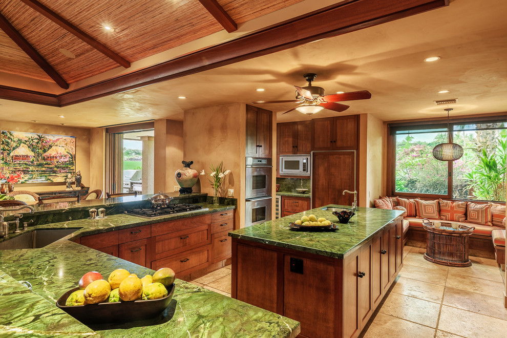 Design ideas for a large tropical l-shaped open plan kitchen in Hawaii with a single-bowl sink, granite benchtops, stainless steel appliances, travertine floors and with island.