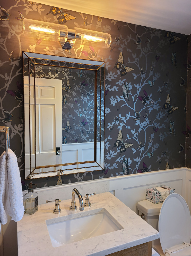 Medium sized classic shower room bathroom in Boston with raised-panel cabinets, light wood cabinets, a two-piece toilet, multi-coloured walls, ceramic flooring, a submerged sink, marble worktops, white floors, white worktops, a single sink, a freestanding vanity unit and wallpapered walls.
