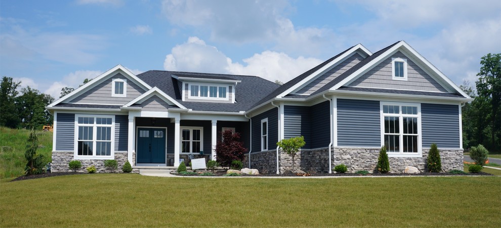 This is an example of an arts and crafts one-storey grey exterior in Cleveland with vinyl siding.