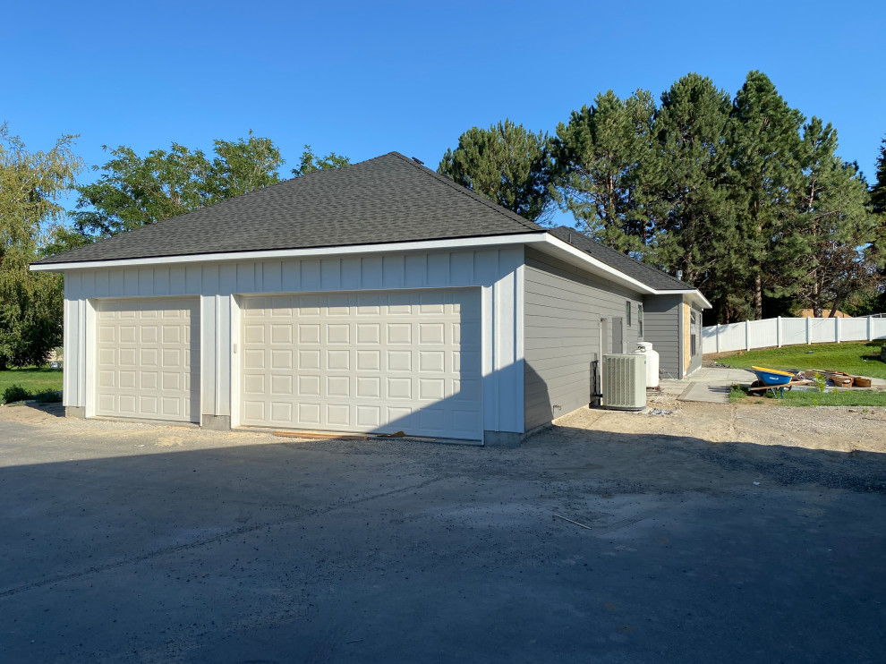 Inspiration for a huge transitional multicolored one-story concrete and board and batten house exterior remodel with a hip roof, a shingle roof and a black roof