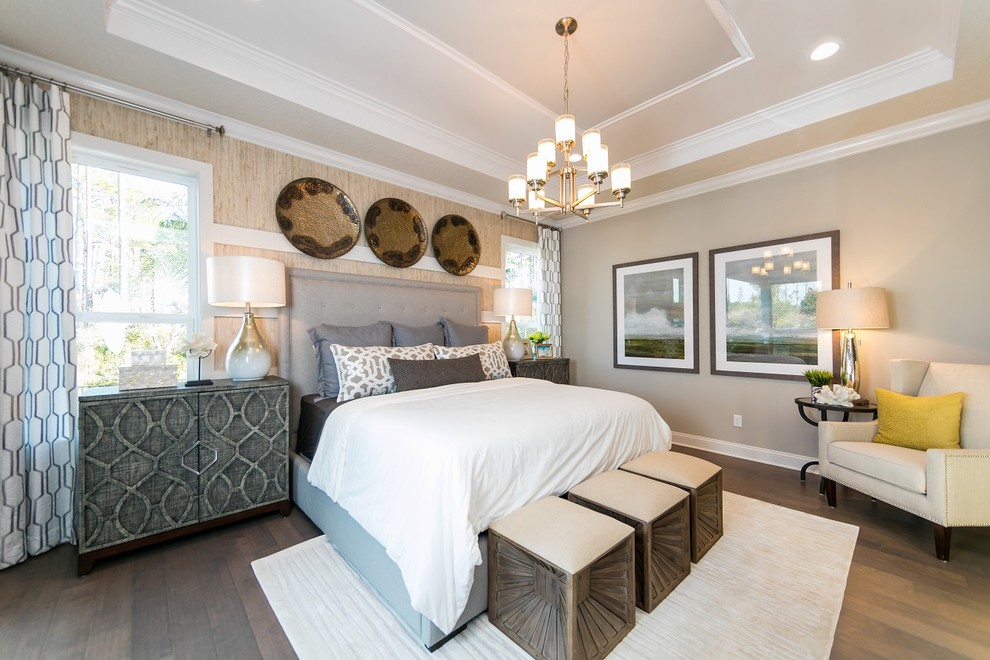 Photo of a mid-sized beach style master bedroom in Jacksonville with grey walls and medium hardwood floors.