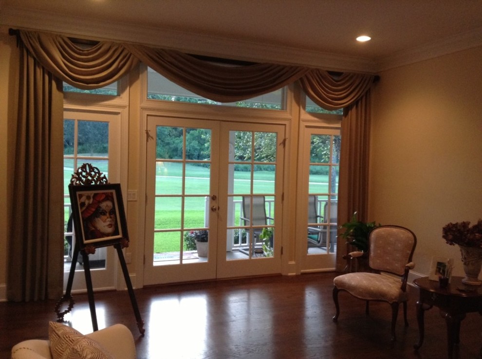 This is an example of a large transitional formal enclosed living room in Jacksonville with dark hardwood floors, no tv and beige walls.