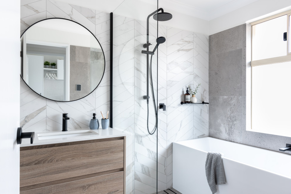 Inspiration for a mid-sized contemporary master wet room bathroom in Perth with flat-panel cabinets, light wood cabinets, a freestanding tub, gray tile, an undermount sink, an open shower, white benchtops, a single vanity and a floating vanity.