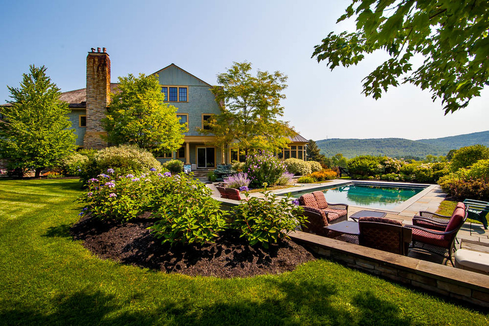 Inspiration for an expansive country backyard full sun garden for summer in Boston with natural stone pavers.
