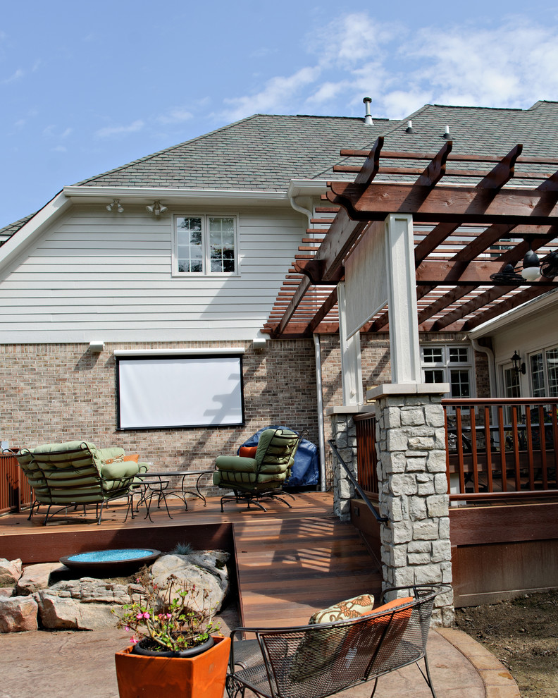 Photo of a large transitional backyard deck in Indianapolis with a fire feature and a pergola.