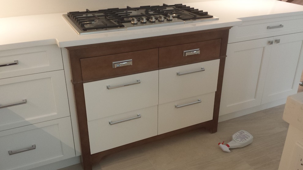 Example of a transitional kitchen design in New York with shaker cabinets and white cabinets