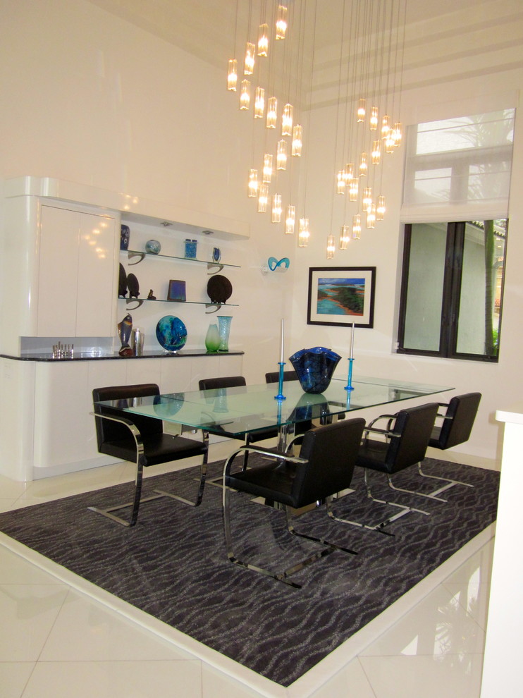 Large contemporary open plan dining in Miami with white walls and marble floors.