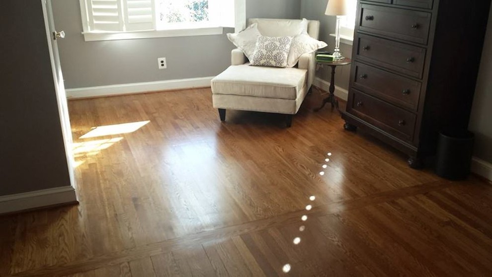 Inspiration for a mid-sized transitional master light wood floor bedroom remodel in Baltimore with gray walls