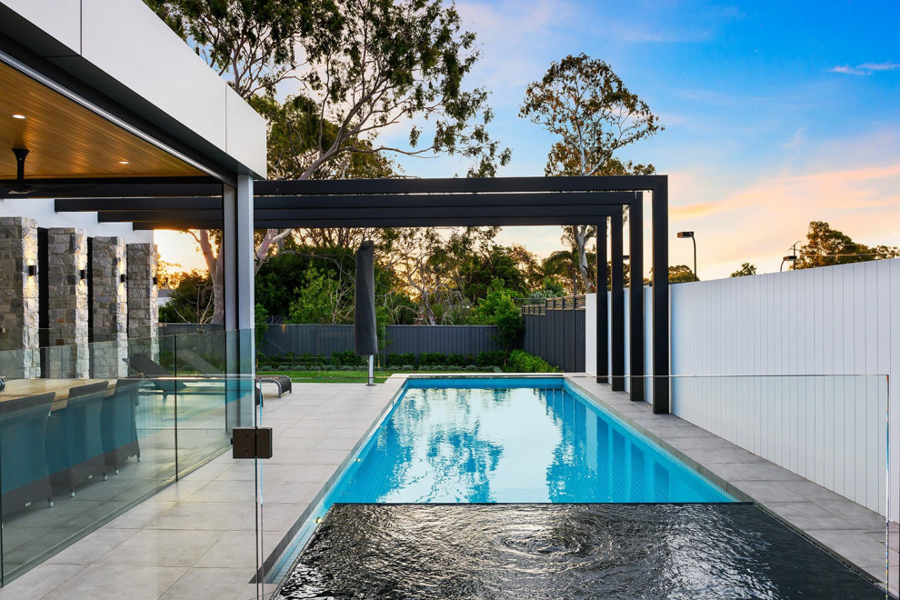 Design ideas for a mid-sized modern backyard rectangular lap pool in Adelaide with a hot tub.