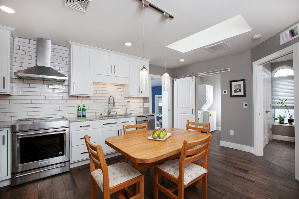 Example of a mid-sized transitional l-shaped porcelain tile and multicolored floor eat-in kitchen design with an undermount sink, shaker cabinets, white cabinets, quartz countertops, white backsplash, subway tile backsplash, stainless steel appliances, no island and white countertops