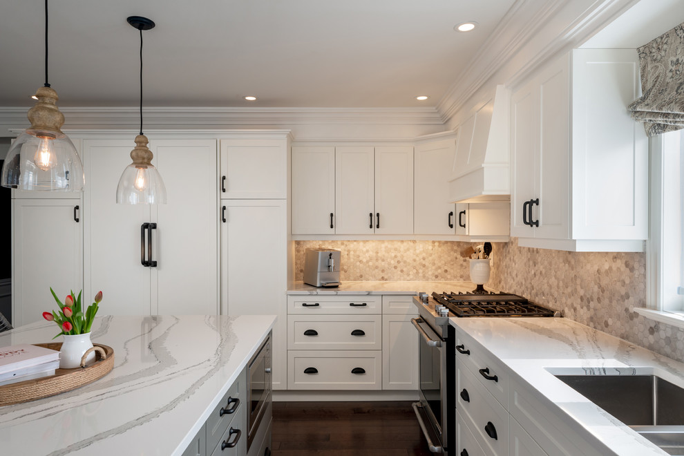 Inspiration for a transitional dark wood floor and brown floor kitchen remodel with white cabinets, quartz countertops, paneled appliances, an island and white countertops