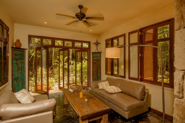 This is an example of a tropical family room in Other.