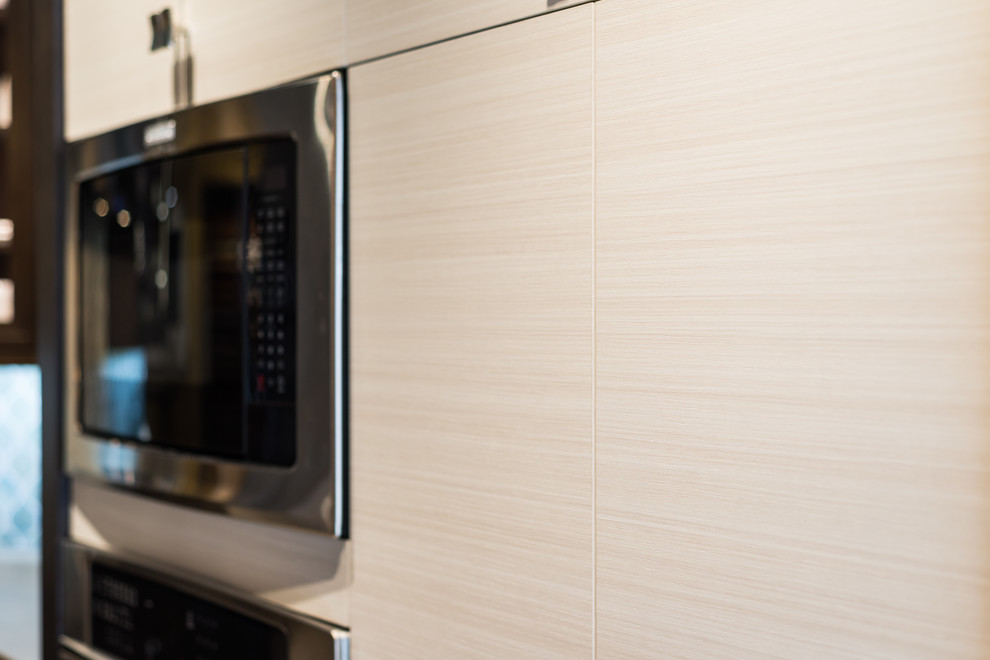 Transitional kitchen photo in Phoenix with flat-panel cabinets, light wood cabinets, concrete countertops, blue backsplash, ceramic backsplash and stainless steel appliances