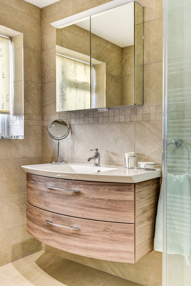 Photo of a small shower room bathroom in Sussex with medium wood cabinets, a corner shower, a two-piece toilet, beige tiles, ceramic tiles, beige walls, vinyl flooring, a built-in sink, beige floors, a hinged door, feature lighting, a single sink and a floating vanity unit.