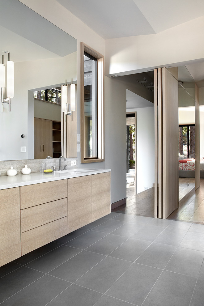 Contemporary bathroom in San Francisco with an undermount sink, flat-panel cabinets, light wood cabinets and white walls.