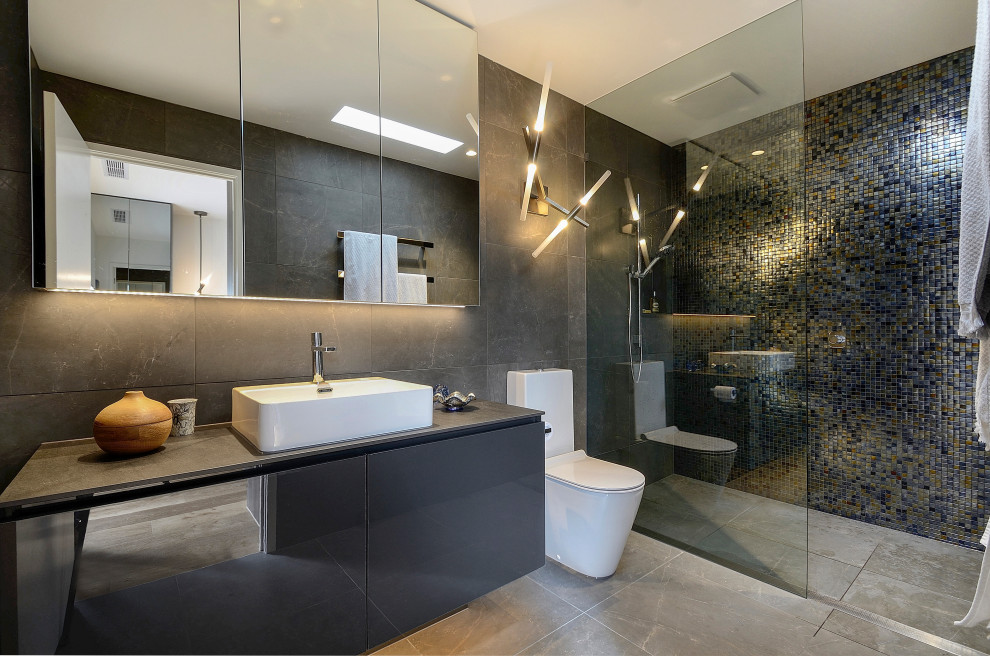 Design ideas for a contemporary bathroom in Melbourne with flat-panel cabinets, grey cabinets, a curbless shower, gray tile, mosaic tile, a vessel sink, grey floor, grey benchtops, a single vanity and a floating vanity.