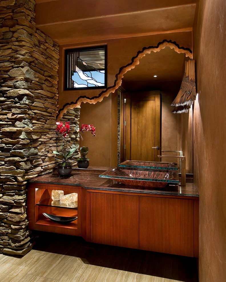 Design ideas for a large contemporary powder room in Phoenix with a vessel sink, furniture-like cabinets, medium wood cabinets, travertine floors, brown walls, granite benchtops and brown benchtops.