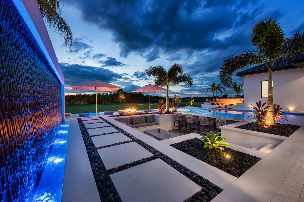 Expansive modern backyard patio in Tampa with tile and no cover.
