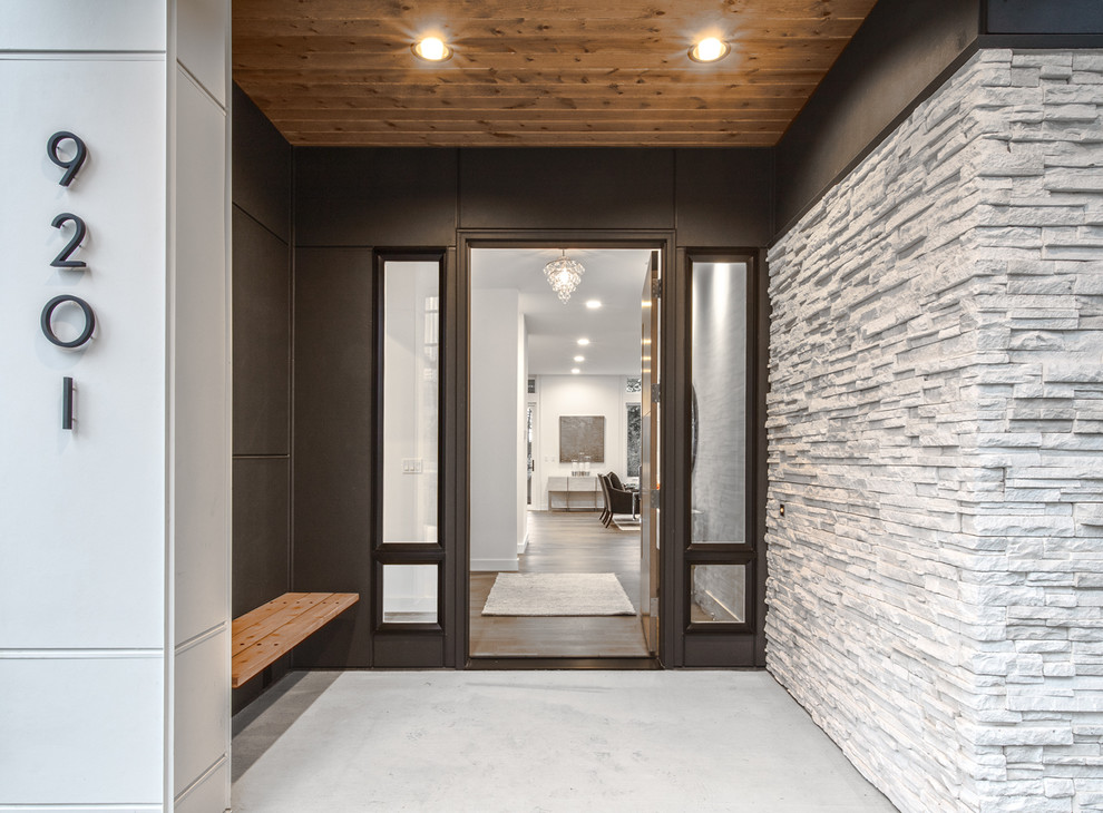 Photo of a mid-sized transitional foyer in Seattle with white walls, medium hardwood floors, a single front door, a medium wood front door and brown floor.