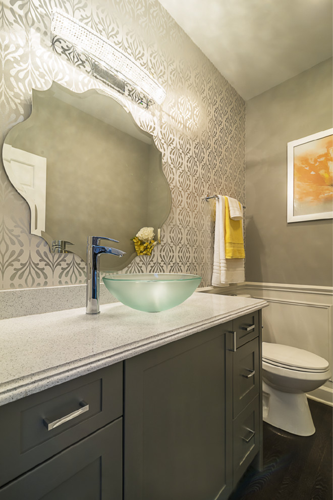 Inspiration for a mid-sized transitional powder room in Chicago with shaker cabinets, grey cabinets, a two-piece toilet, grey walls, dark hardwood floors, a vessel sink and engineered quartz benchtops.