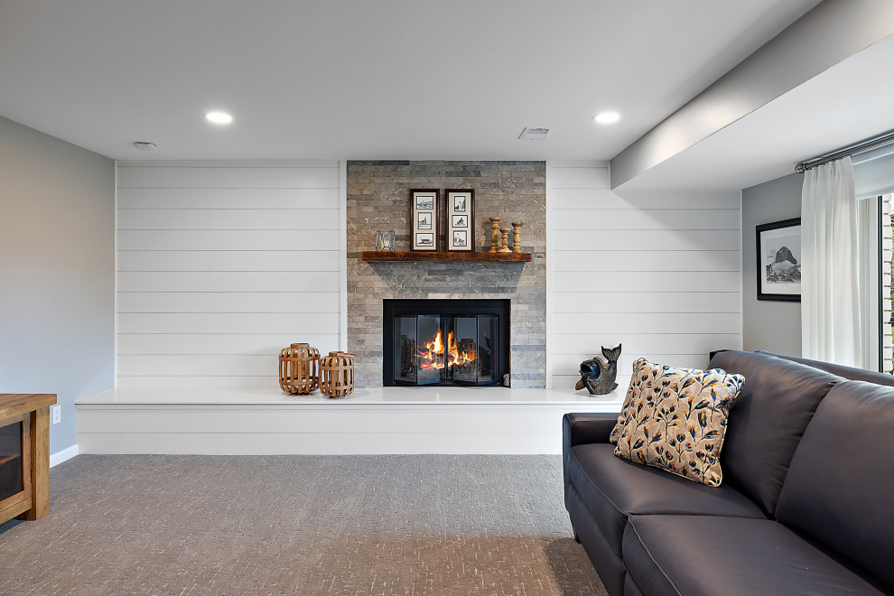 Photo of a large beach style formal mezzanine living room in Detroit with white walls, carpet, a standard fireplace, a stone fireplace surround, a freestanding tv, grey floors, a timber clad ceiling and tongue and groove walls.