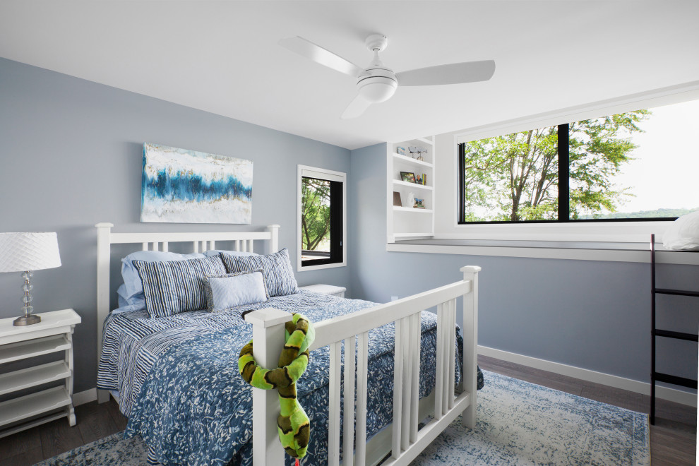 Ejemplo de habitación de invitados moderna de tamaño medio con paredes azules, suelo vinílico y suelo verde