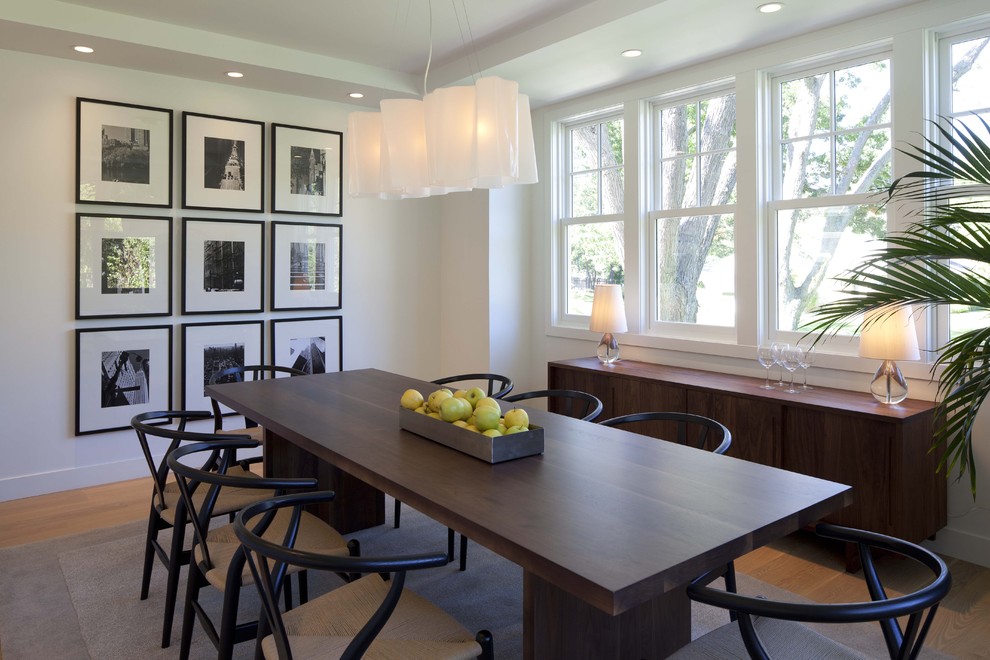 Inspiration for a transitional dining room in Minneapolis with white walls, medium hardwood floors and beige floor.