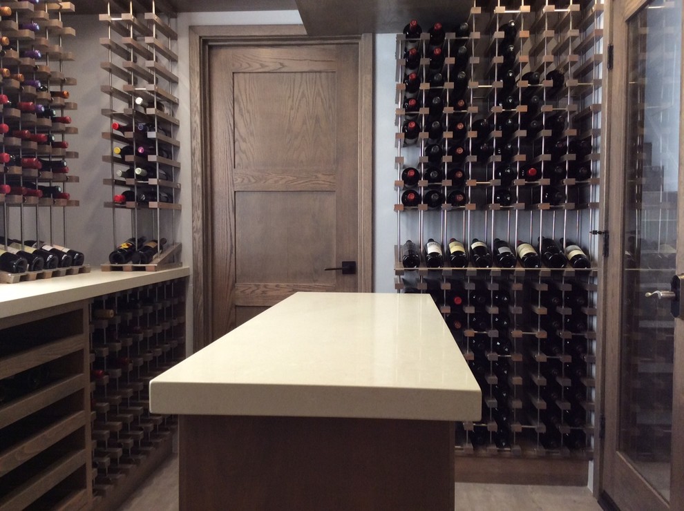 Design ideas for a mid-sized industrial wine cellar in Los Angeles with ceramic floors and display racks.
