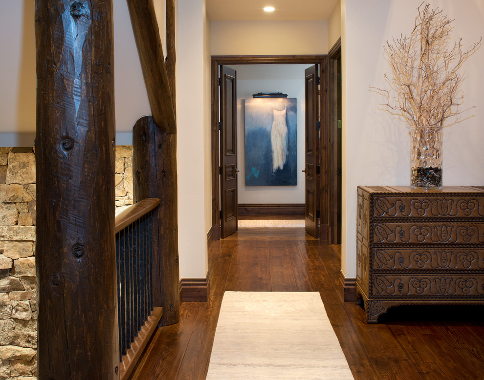 Photo of a country hallway in Denver with white walls and dark hardwood floors.