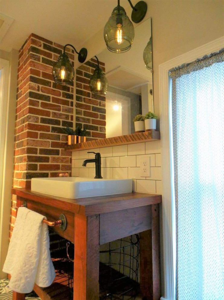 Small victorian ensuite bathroom in Philadelphia with a freestanding vanity unit and brick walls.