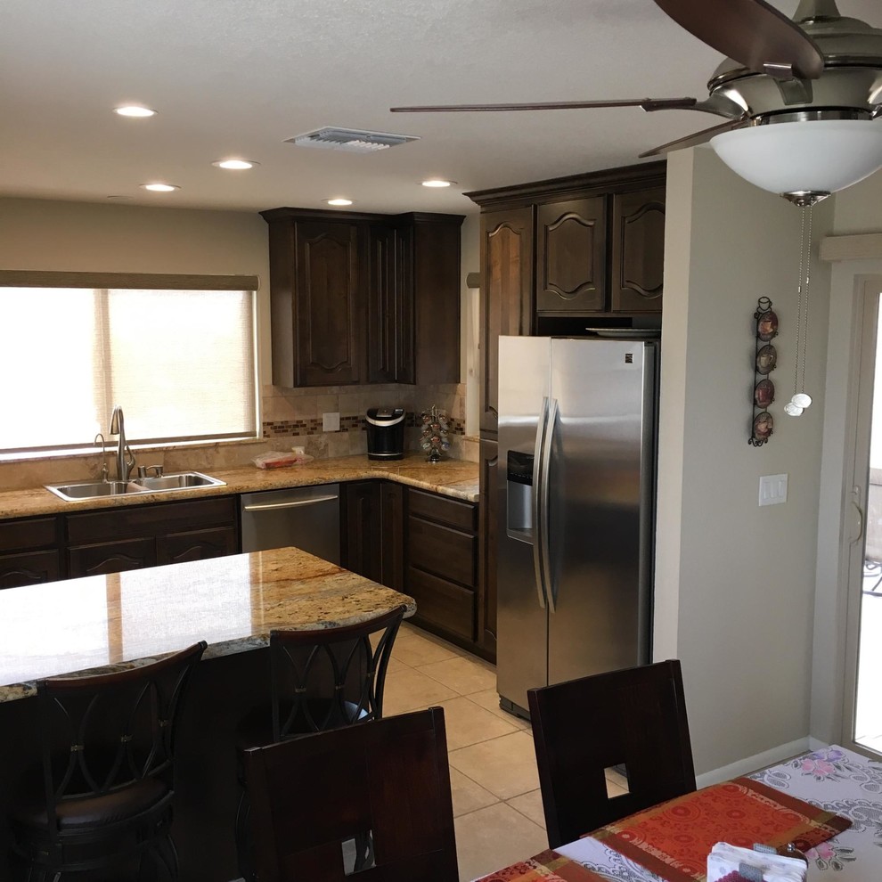 Small transitional u-shaped eat-in kitchen photo in Phoenix with a drop-in sink, beaded inset cabinets, dark wood cabinets, granite countertops, stone tile backsplash, stainless steel appliances and no island