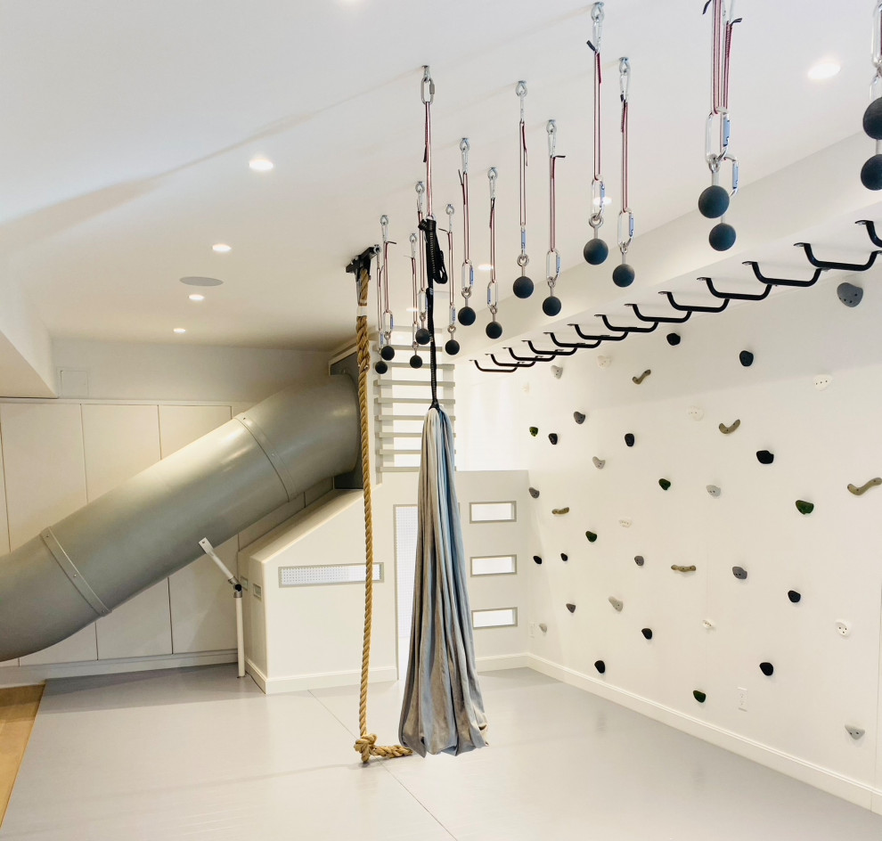Minimalist perfection! - Playroom - mid-sized cottage gender-neutral light wood floor, gray floor, wood ceiling and wall paneling playroom idea in New York with white walls