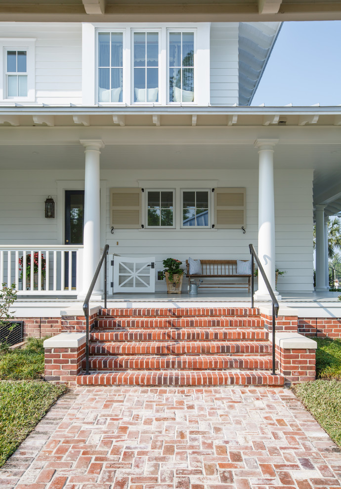 Country white three-story concrete fiberboard house exterior photo in Jacksonville with a hip roof and a metal roof